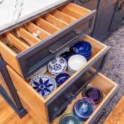 blue kitchen island with dishware in drawers