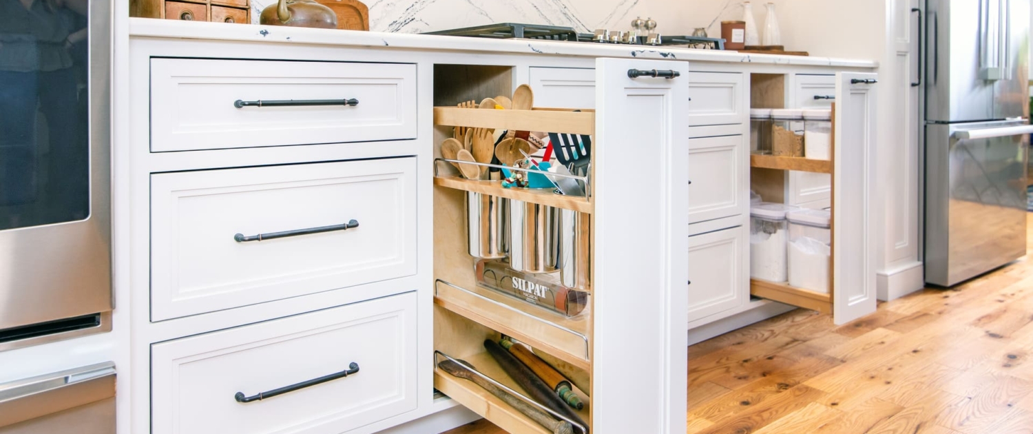 white kitchen with utensil drawers