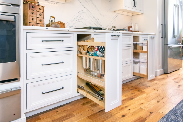 white kitchen with utensil drawers