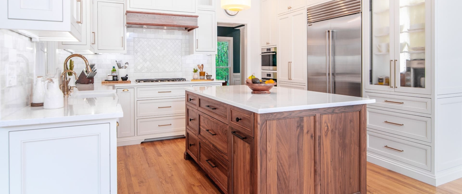 white kitchen with walnut island
