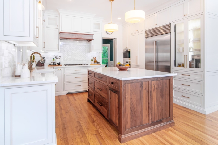 white kitchen with walnut island