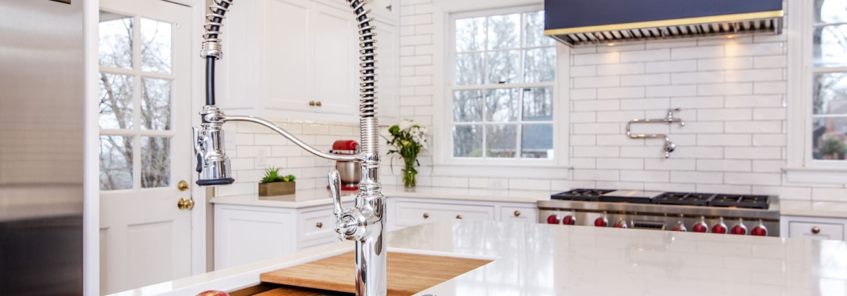 White kitchen cabinets with a large blue hood