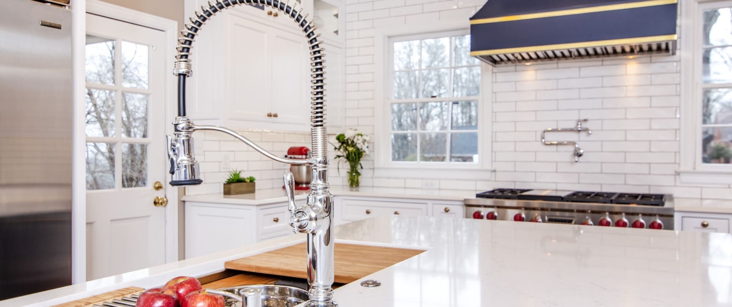 White kitchen cabinets with a large blue hood