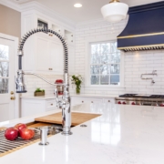 White kitchen cabinets with a large blue hood