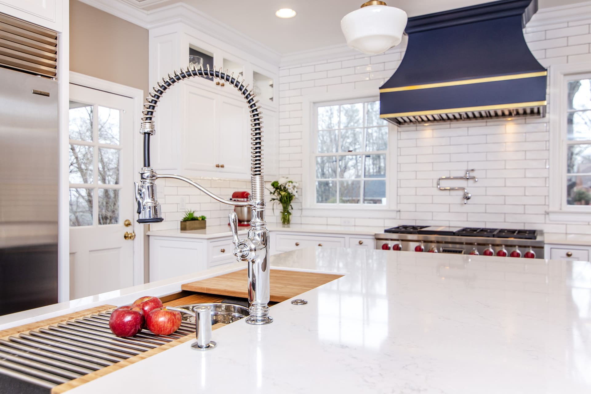 White kitchen cabinets with a large blue hood