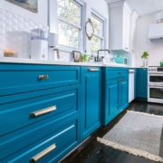 teal kitchen with hardwood floors