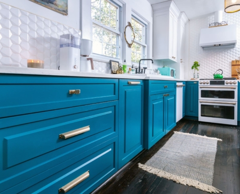 teal kitchen with hardwood floors
