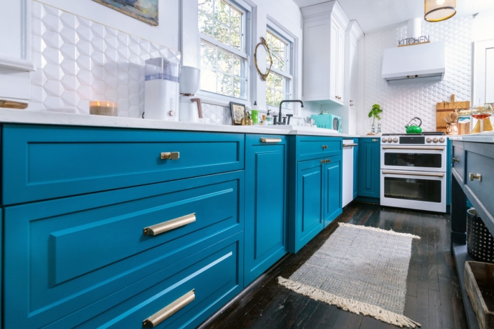 teal kitchen with hardwood floors