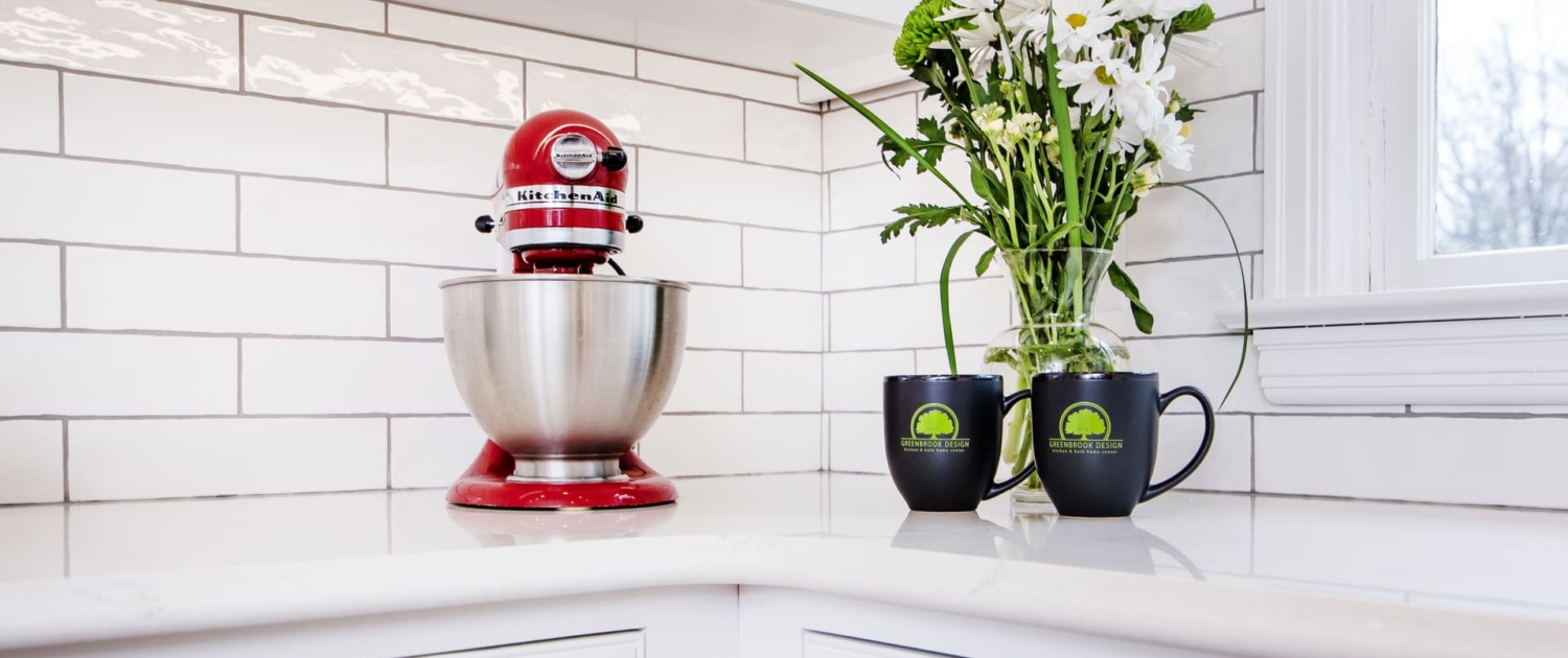 Kitchen aid mixer and coffee mugs on a kitchen countertop