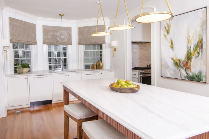 kitchen with a walnut island and a large painting