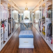 Custom closet with glass doors and an island