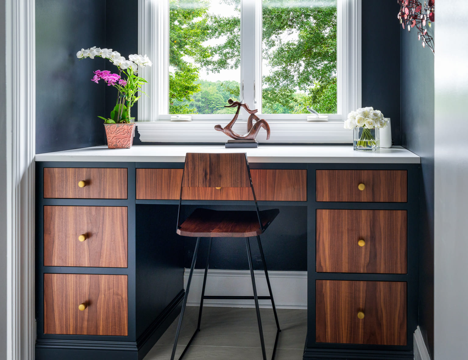 Office with blue and walnut cabinets