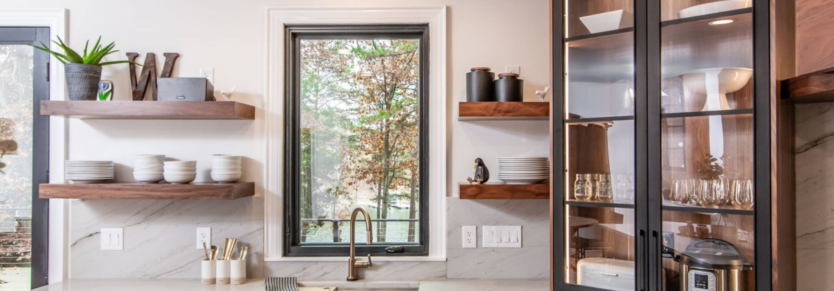 Walnut cabinets with a window and white backsplash
