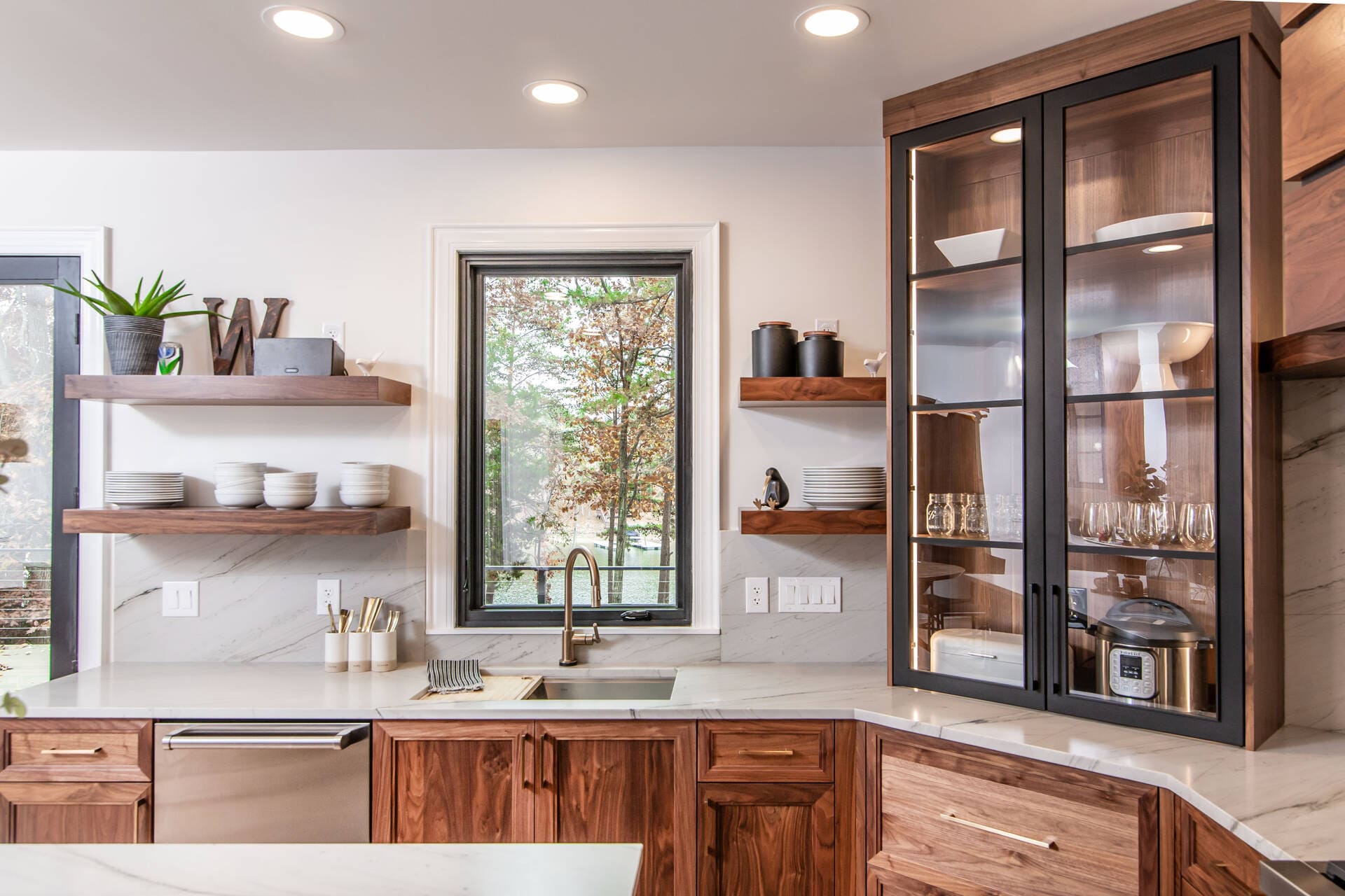 Walnut cabinets with a window and white backsplash
