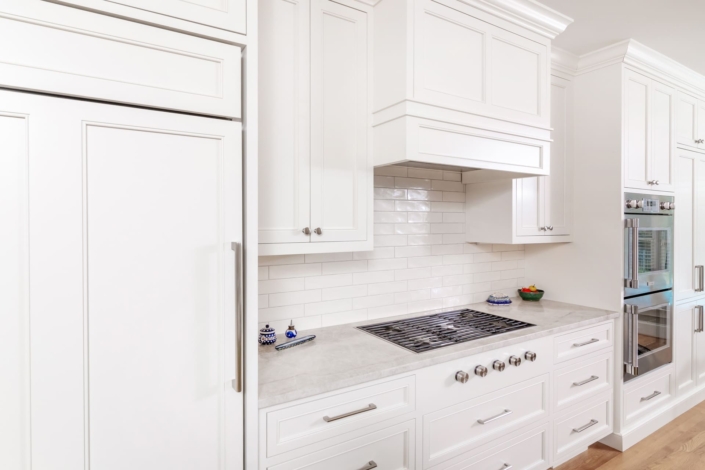 tile backsplash and a white hood