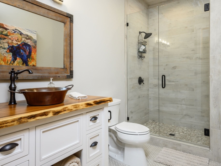 bathroom with a copper sink and walk in shower