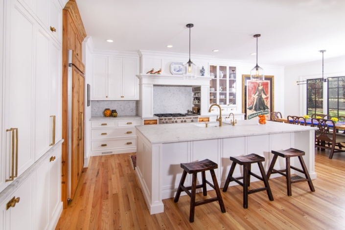 white kitchen with paneled appliances