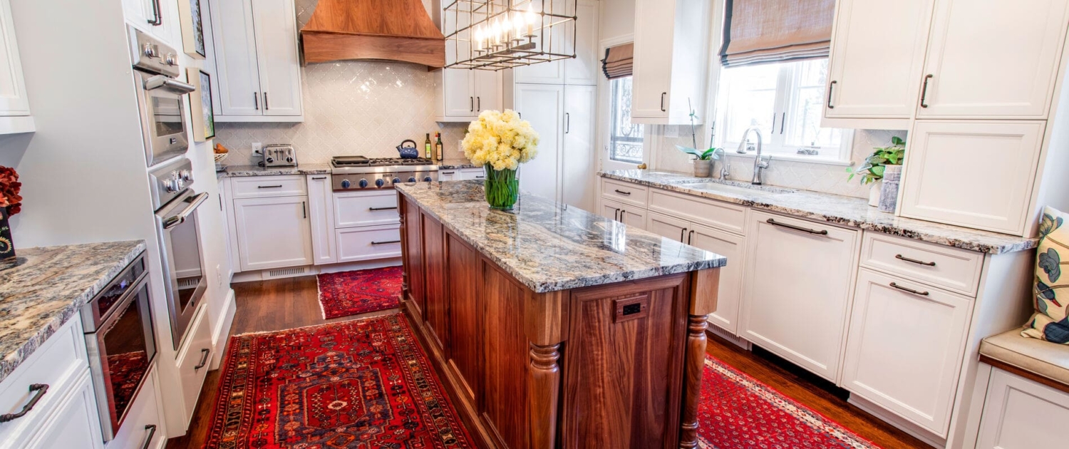 white kitchen with a walnut island