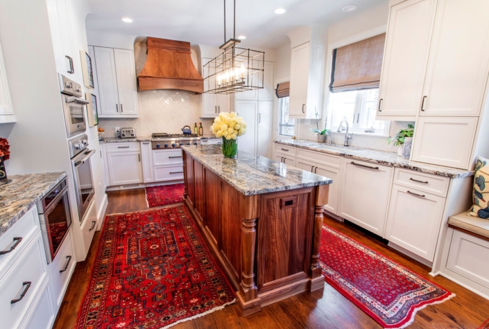 white kitchen with a walnut island