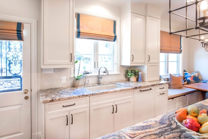 white kitchen with a sink and windows