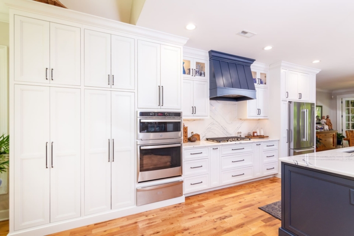 white kitchen with a blue hood and blue island