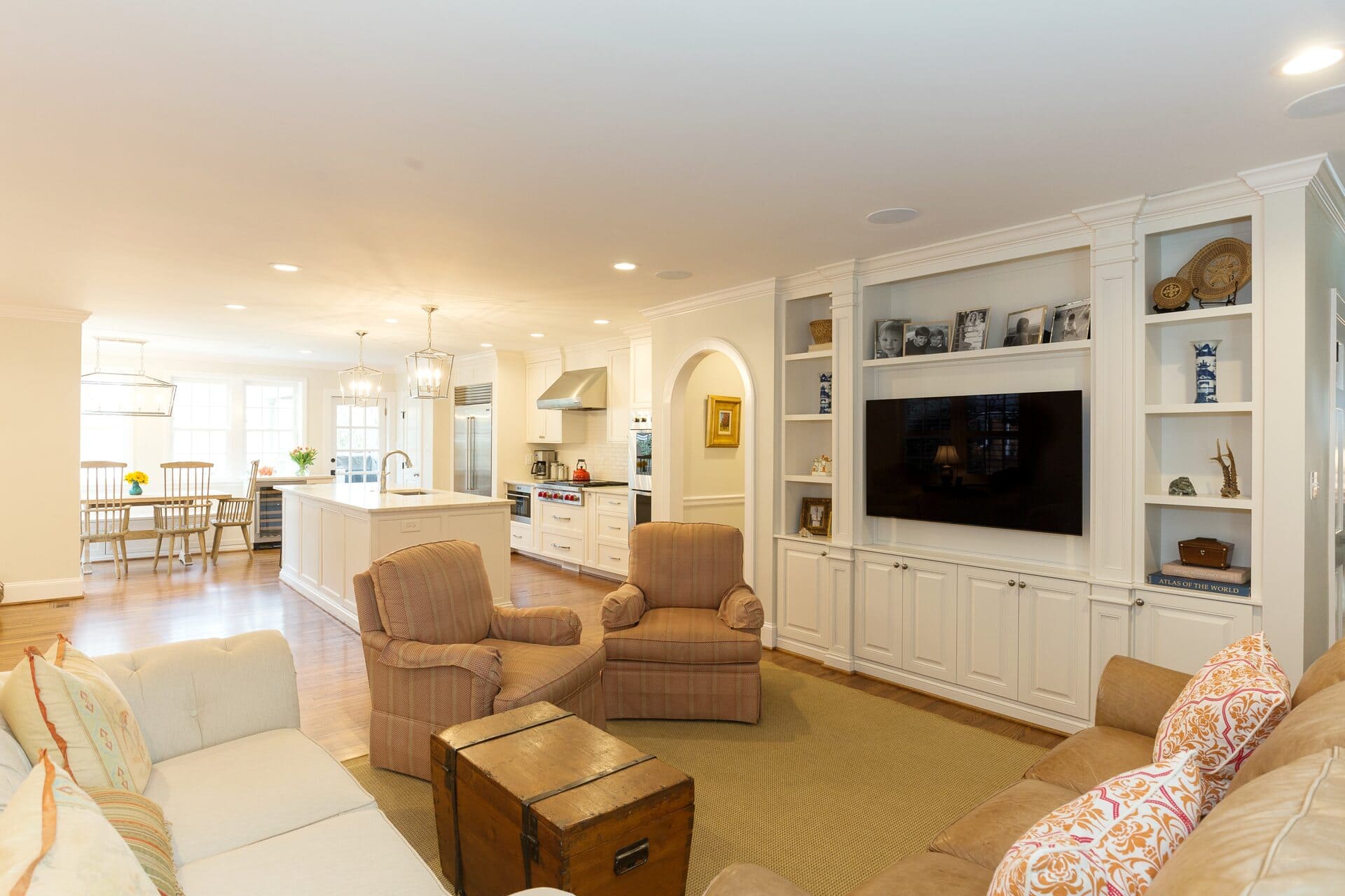 living room and kitchen with a large entertainment center
