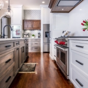 white kitchen and brown island with hardwood floors