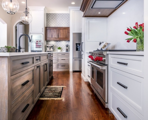 white kitchen and brown island with hardwood floors