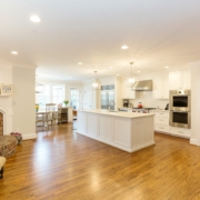 white kitchen and living room with a fireplace