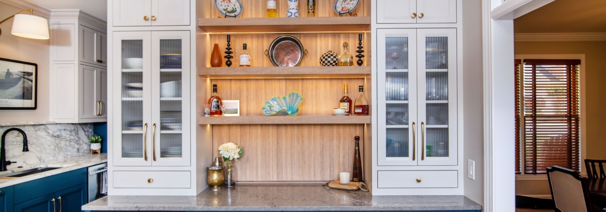 Oak, white, and blue kitchen cabinets with a pass through door