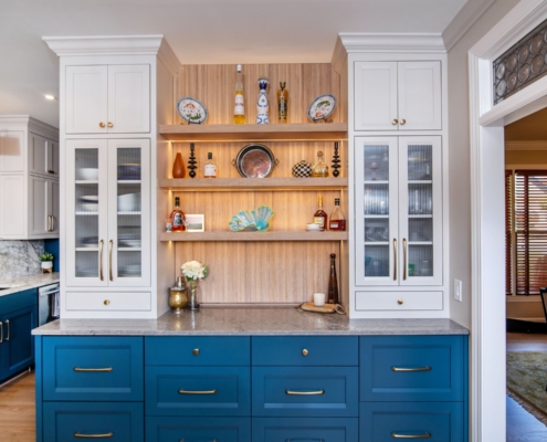 Oak, white, and blue kitchen cabinets with a pass through door