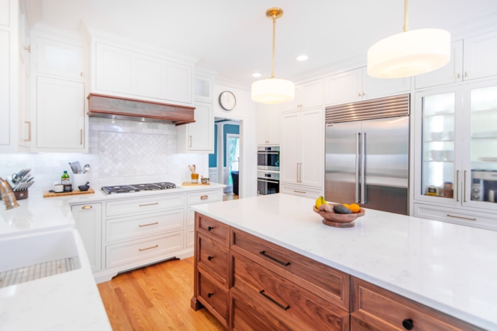 walnut island with gold light fixtures