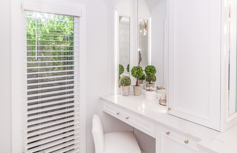 White bathroom vanity with a chair