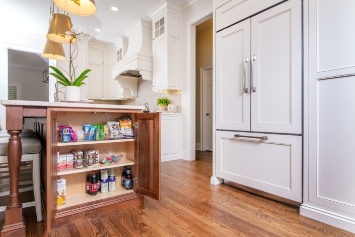 panel fridge with a walnut island