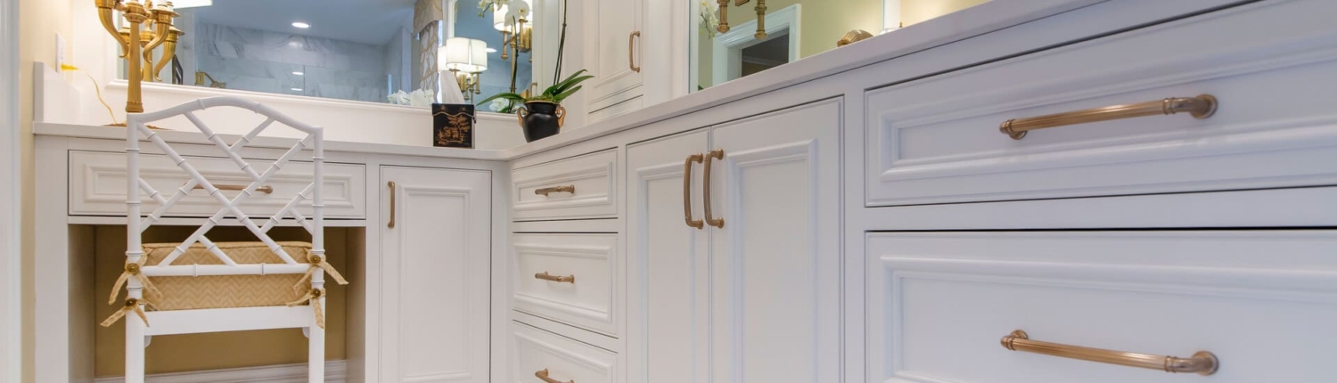 white bathroom vanity with gold lights