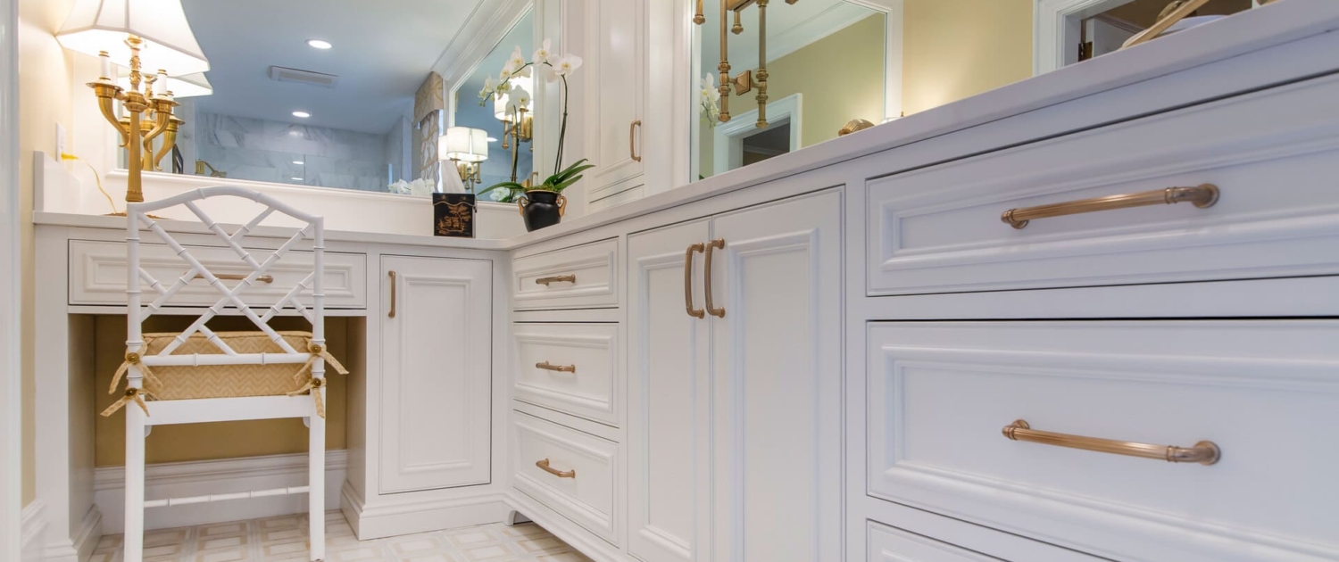white bathroom vanity with gold lights
