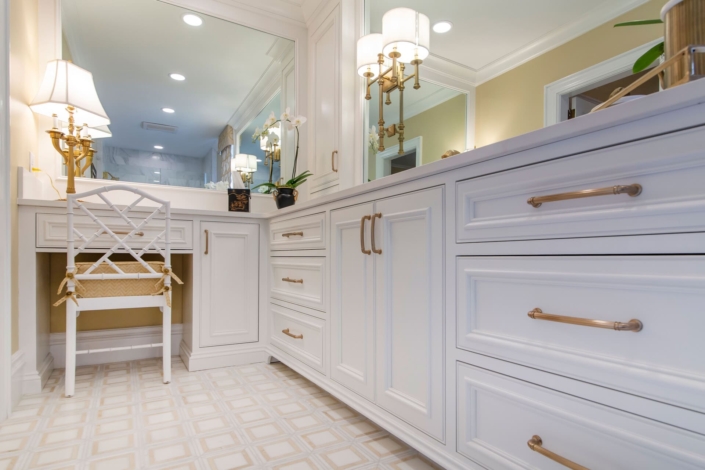 white bathroom vanity with gold lights