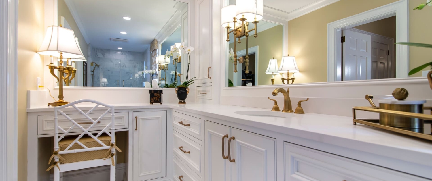bathroom with big mirrors and gold lights