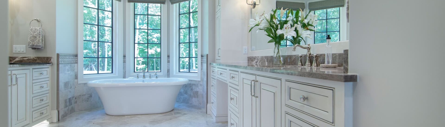 two bathroom vanities with a large tub