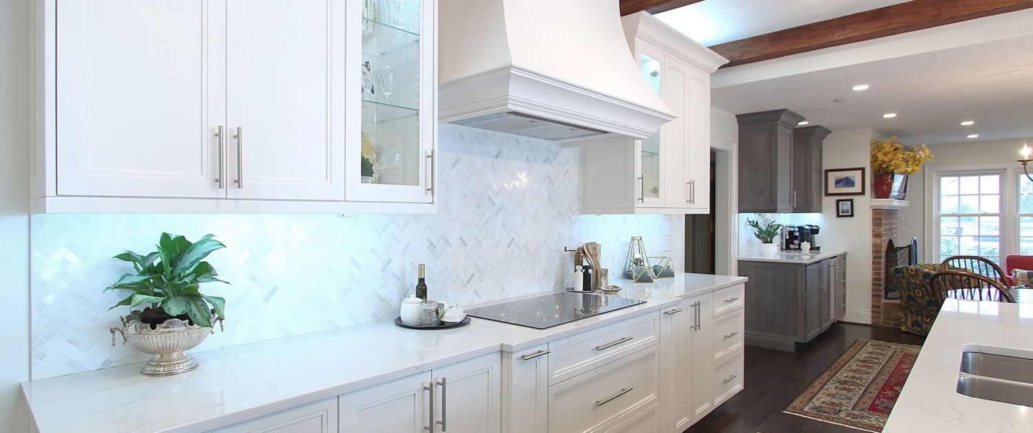white kitchen cabinets with a large hood