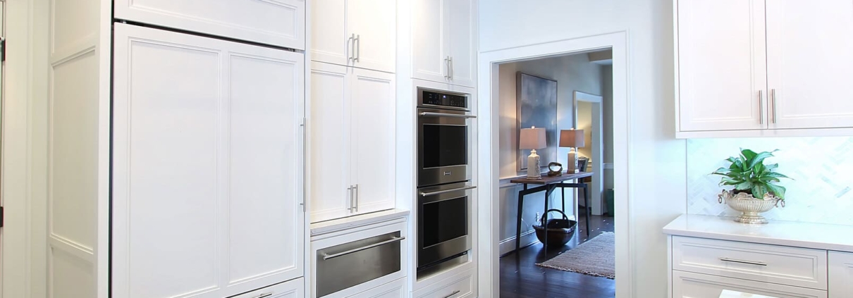 white kitchen with wooden ceiling beams