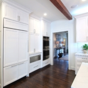 white kitchen with wooden ceiling beams
