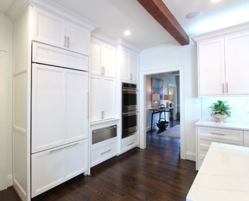 white kitchen with wooden ceiling beams