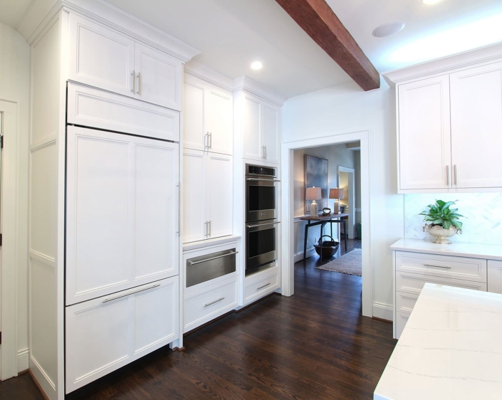white kitchen with wooden ceiling beams