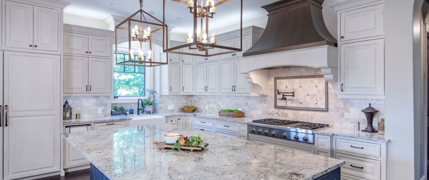 kitchen with a blue island and brown hood