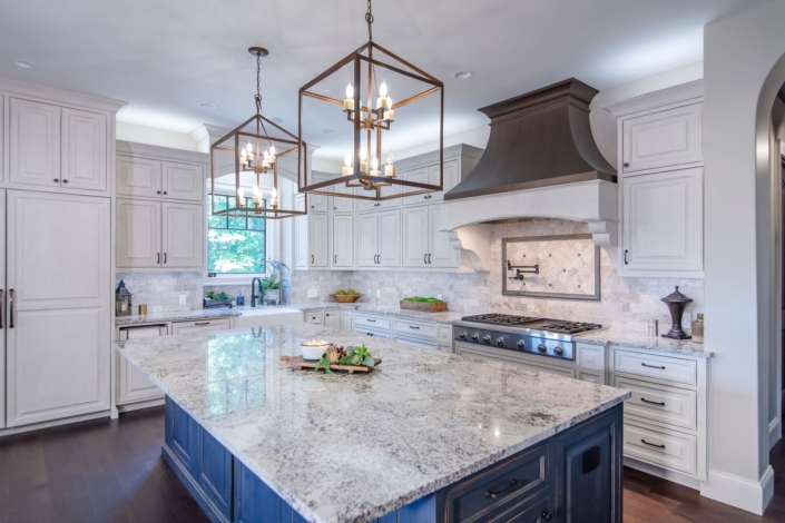 kitchen with a blue island and brown hood