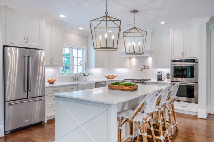 white kitchen with gold lights and flowers
