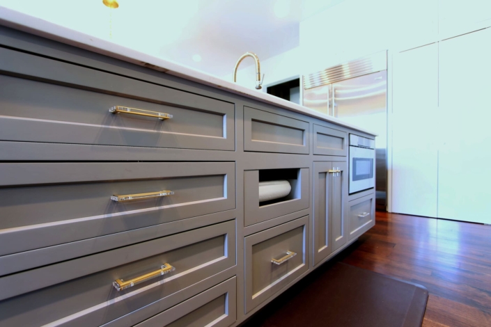 grey island with a paper towel holder