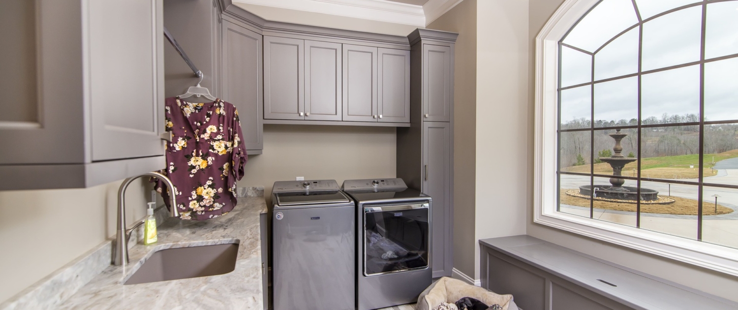 A laundry room with a large window
