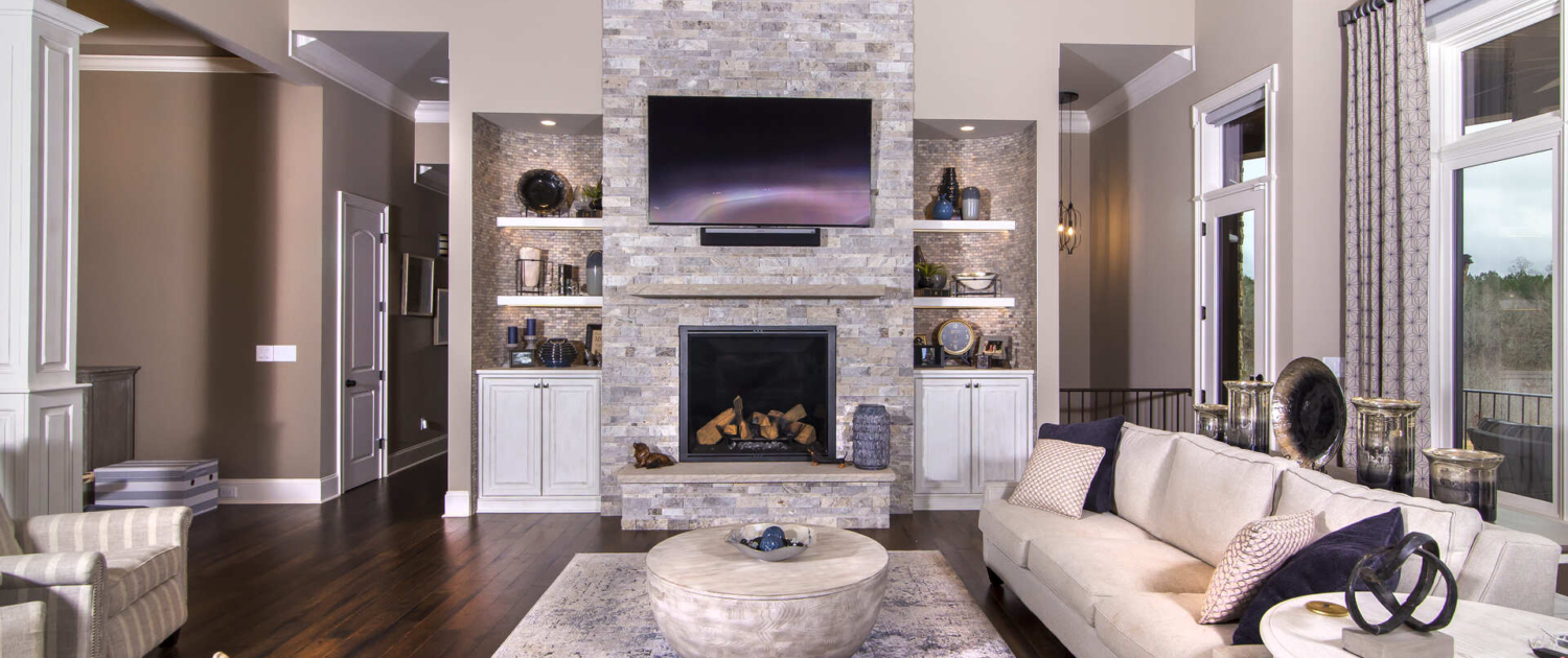 Living room with a large mantle and TV
